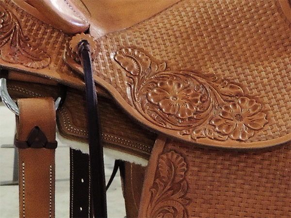 Close up of tooling on western saddle