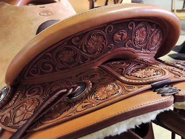 closeup of leather carving on Tom Rolfe's winning saddle