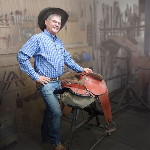 Pete Comiskey in the Toowoomba Saddlery workshop with a completed Pro Drafter saddle